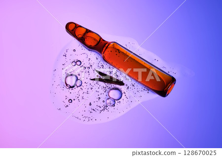 An ampoule with serum in its texture on a purple background with a leaf. 128670025