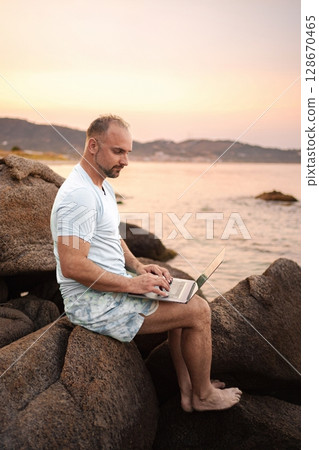 Family enjoying a sunset beach day with laughter and joy 128670465