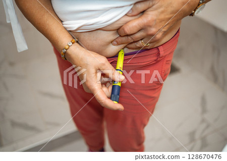 Managing diabetes with an insulin pen in a cozy home setting Managing diabetes with an insulin pen in a cozy home setting 128670476