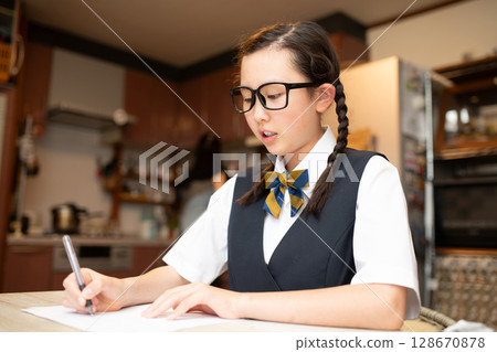 Female junior high school student studying at home Female junior high school student studying at home 128670878