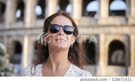 Fashionable woman posing by the Colosseum in Rome Italy  128671811