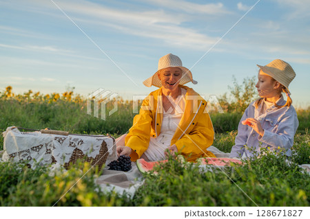 Enjoying a Joyful Outdoor Picnic Experience with Close Friends on a Beautiful Day Enjoying a Joyful Outdoor Picnic Experience with Close Friends on a Beautiful Day 128671827