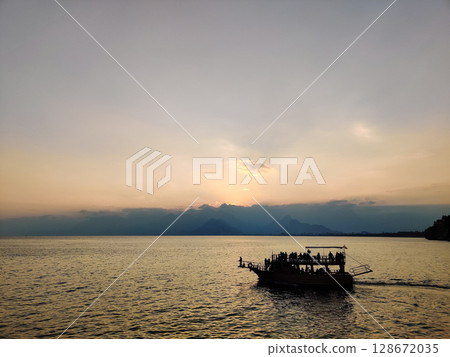 a beautiful ship is sailing in the blue sea 128672035