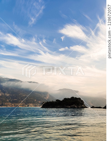 beautiful seascape on the horizon silhouette of mountains beautiful seascape on the horizon silhouette of mountains 128672057