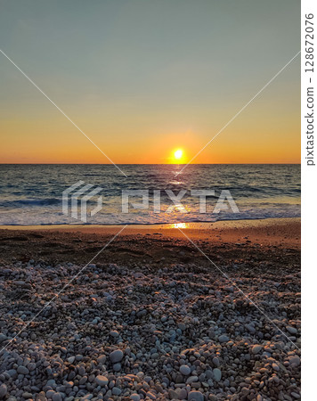 beautiful dramatic landscape of sunset on the sea beach 128672076