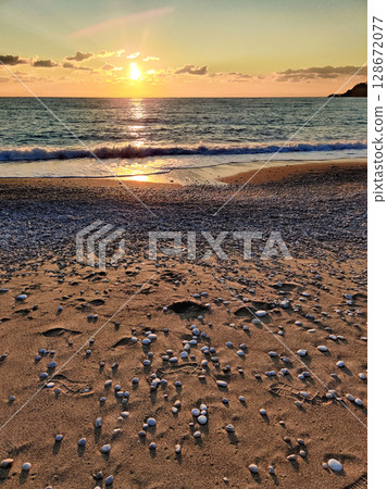 beautiful dramatic landscape of sunset on the sea beach 128672077