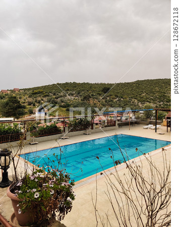 a beautiful large swimming pool near the house a beautiful large swimming pool near the house 128672118
