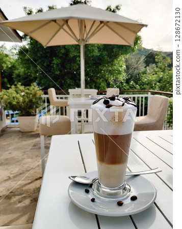 close-up of a three-layer coffee latte in a transparent glass close-up of a three-layer coffee latte in a transparent glass 128672130