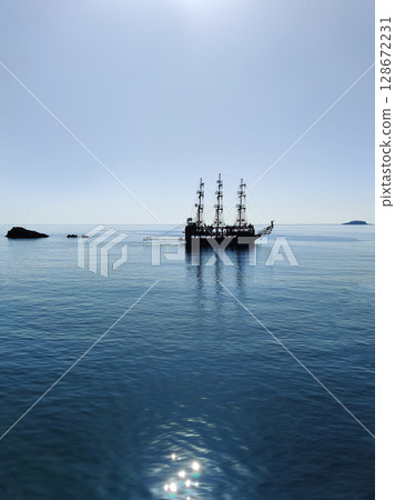 a beautiful ship is sailing in the blue sea 128672231