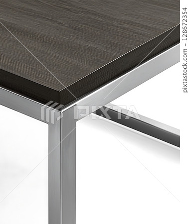 A table with a dark wood top and silver legs 128672354