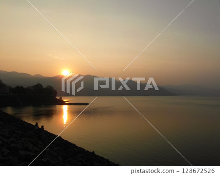 beautiful landscape of mountains on the sea coast at sunset 128672526
