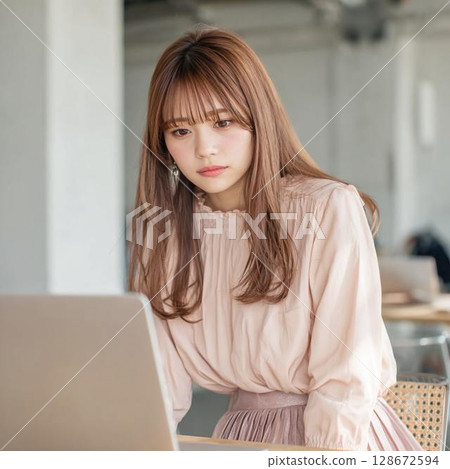 A woman using a computer in a cafe 128672594