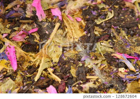 This close-up captures a vibrant mix of dried flowers and herbs, showcasing deep purples 128672604