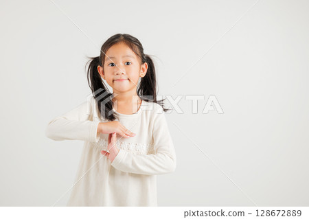 Closeup portrait young kid girl smiling making give time out gesture with hands studio shot isolated on white background, kindergarten child demonstrates break hand sign, stop time with copy space 128672889