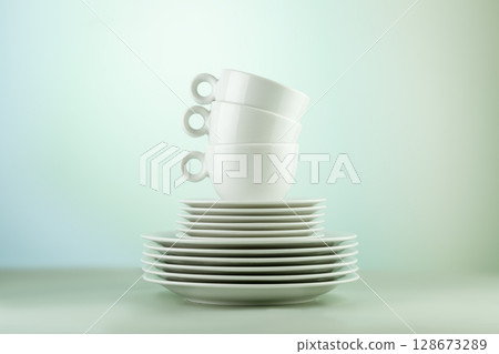 Clean, empty white dishes and cups on blue gradient background. Eco friendly washing dishes and cleaning. Dishes, porcelain background. Front view Clean, empty white dishes and cups on blue gradient background. Eco friendly washing dishes and cleaning. Dishes, porcelain background. Front view 128673289