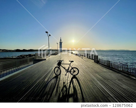 Lighthouse and bicycle 128675062