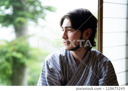 Inbound tourists wearing yukata sitting by the window of a ryokan Inbound tourists wearing yukata sitting by the window of a ryokan 128675245