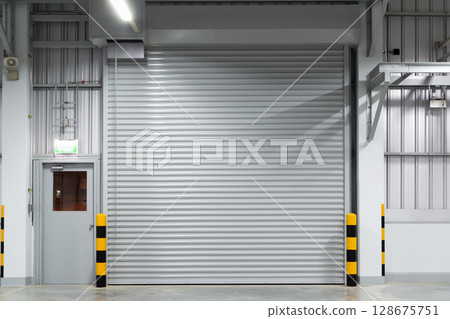 Shutter door in factory warehouse suit for industrial background. 128675751