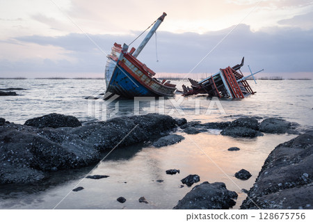 Old wrecked fishing boat on coast of Ang Sila Village, Saensuk Sub-district, Chonburi Province of thailand. Old wrecked fishing boat on coast of Ang Sila Village, Saensuk Sub-district, Chonburi Province of thailand. 128675756