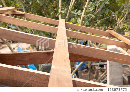 Roof under construction with metal sheet and wood structure. Roof under construction with metal sheet and wood structure. 128675773
