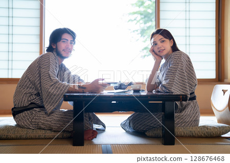 An inbound couple relaxing at a ryokan An inbound couple relaxing at a ryokan 128676468