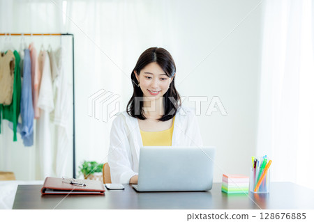 Young woman working remotely Young woman working remotely 128676885
