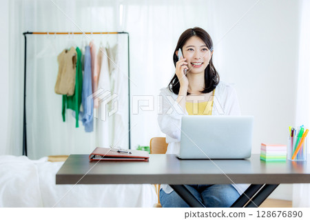 Young woman working remotely Young woman working remotely 128676890