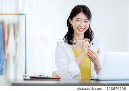 A woman watching a smartphone A woman watching a smartphone 128676896