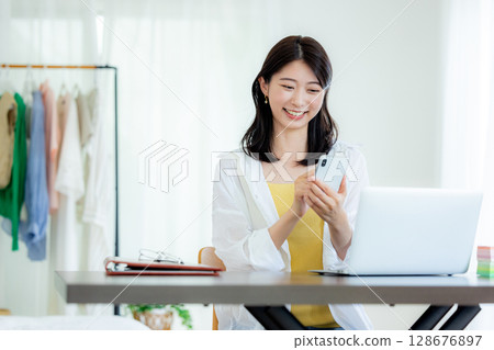 A woman watching a smartphone A woman watching a smartphone 128676897