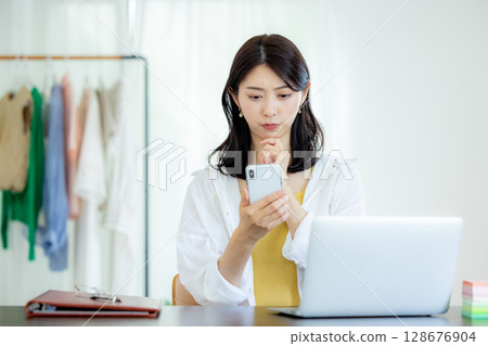 A young woman who has trouble looking at her smartphone 128676904