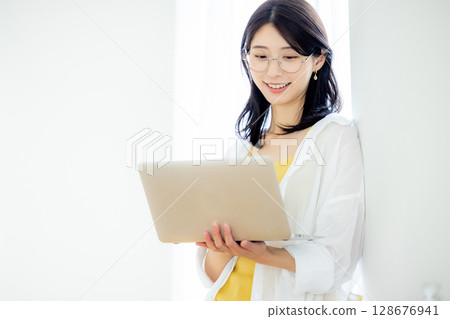 A woman with a laptop A woman with a laptop 128676941