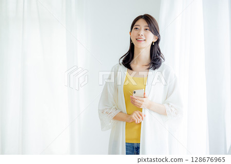 Woman operating a smartphone 128676965