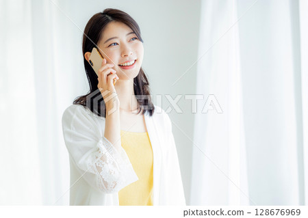 A woman talking on a smartphone 128676969