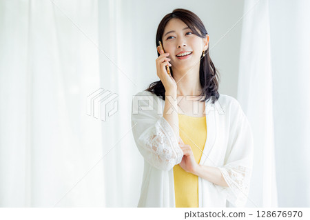A woman talking on a smartphone 128676970