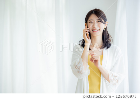 A woman talking on a smartphone 128676975