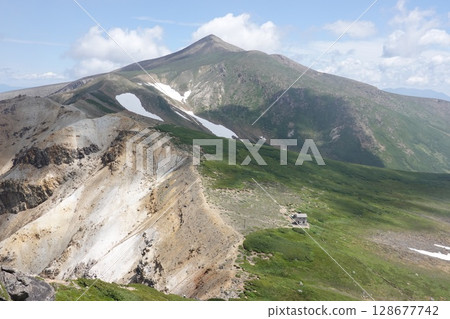 The rebuilt Kamihorokametoku mountain shelter and Mt. Tokachi The rebuilt Kamihorokametoku mountain shelter and Mt. Tokachi 128677742