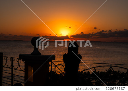 Okinawa sunset and silhouette of a woman Okinawa sunset and silhouette of a woman 128678187