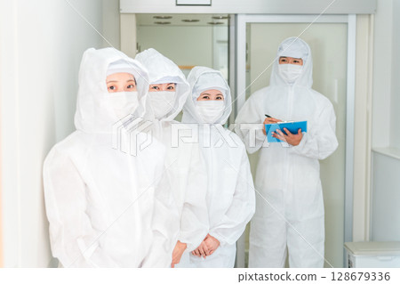 People who work in factories with air showers and clean rooms People who work in factories with air showers and clean rooms 128679336