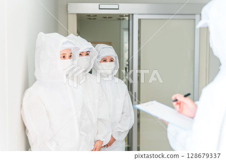 People who work in factories with air showers and clean rooms People who work in factories with air showers and clean rooms 128679337