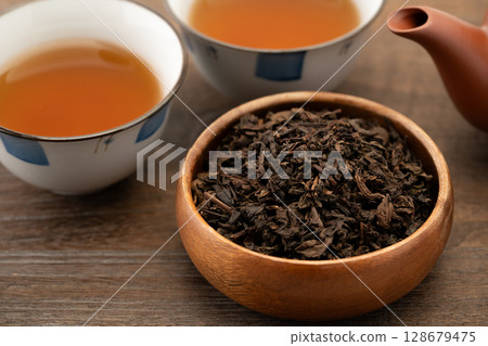 Tea utensils and oolong tea leaves in a bowl Tea utensils and oolong tea leaves in a bowl 128679475