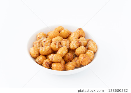 Arare (soy sauce flavor) in a plate on a white background Arare (soy sauce flavor) in a plate on a white background 128680282