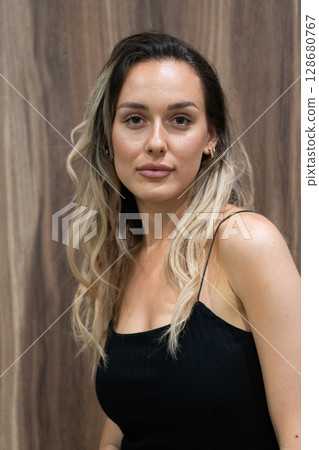 Elegant Blonde in a Black Dress Exuding Confidence and Timeless Beauty. 128680767