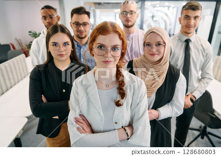 A group of business professionals standing together, taking a well-deserved break from their busy workday, showcasing camaraderie, teamwork, and a moment of relaxation in their dynamic workplace A group of business professionals standing together, taking a well-deserved break from their busy workday, showcasing camaraderie, teamwork, and a moment of relaxation in their dynamic workplace 128680803