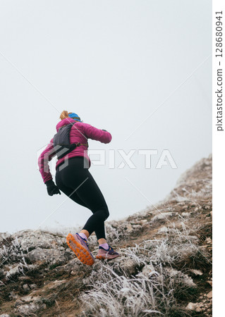Trail Runner in Misty Mountain Landscape 128680941