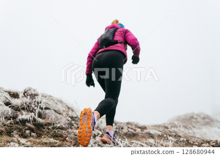 Trail Runner in Misty Mountain Landscape 128680944