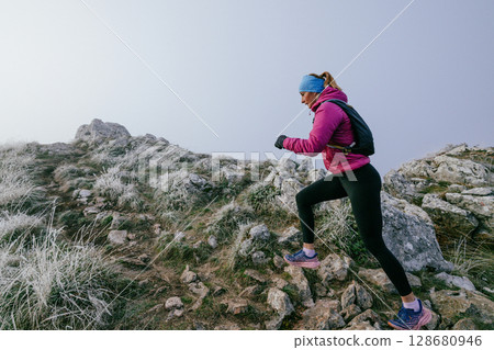Trail Runner in Misty Mountain Landscape 128680946