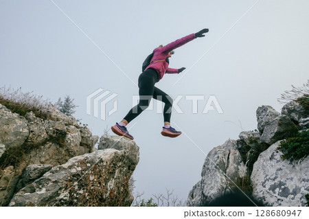Trail Runner in Misty Mountain Landscape 128680947