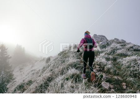 Trail Runner in Misty Mountain Landscape 128680948