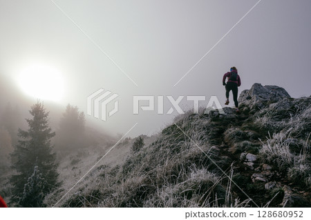 Trail Runner in Misty Mountain Landscape Trail Runner in Misty Mountain Landscape 128680952