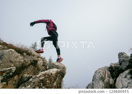 Trail Runner in Misty Mountain Landscape Trail Runner in Misty Mountain Landscape 128680955